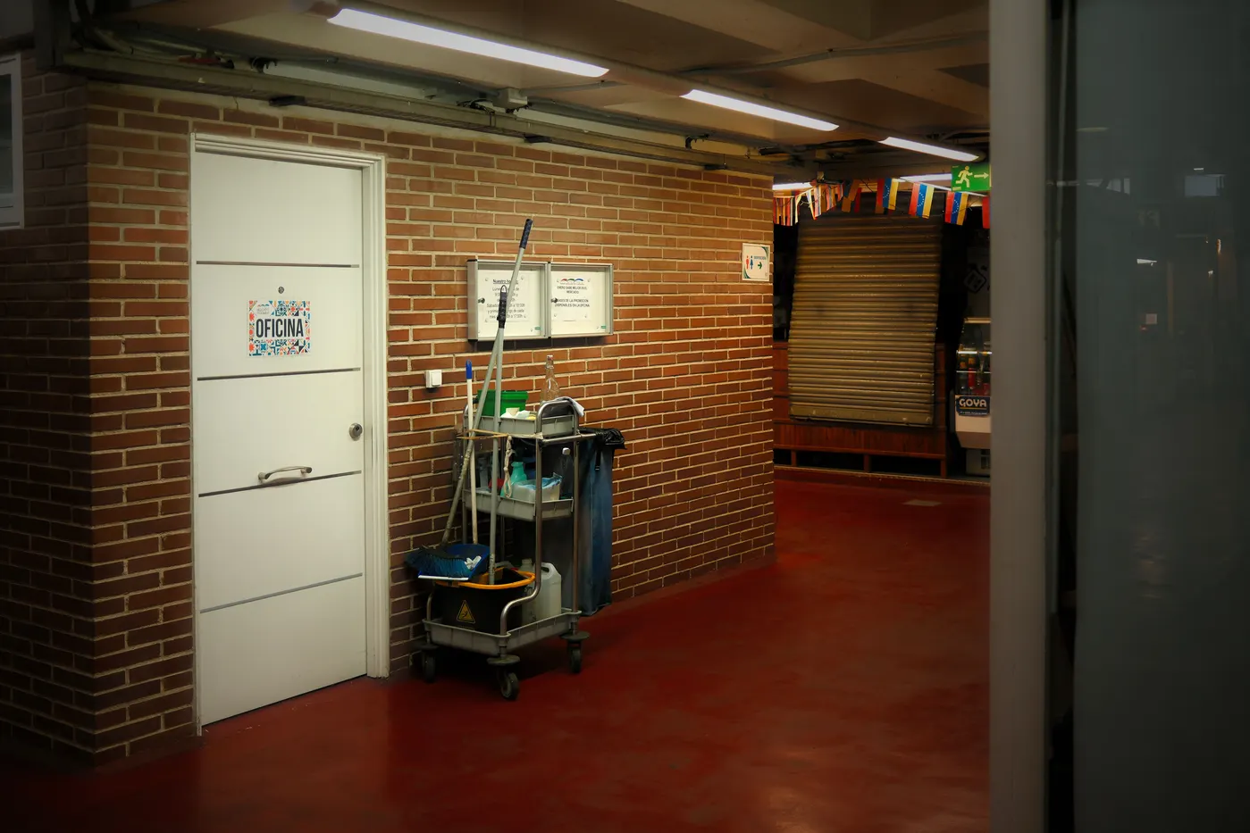 Stock photo of a cleaning cart parked in an office hallway